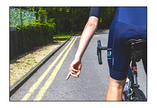 Cyclists Pointing to Debris
