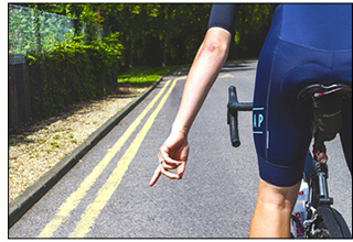Cyclists Pointing to Debris